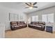 Well-lit living room with dual sofas, neutral walls, and ceiling fan offering a relaxing atmosphere at 2013 E Dust Devil Dr, San Tan Valley, AZ 85143