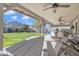 Inviting covered patio overlooking a lush lawn, perfect for outdoor dining and relaxation at 2013 E Dust Devil Dr, San Tan Valley, AZ 85143