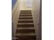 Carpeted stairway leading upwards, with a window providing natural light and a neutral color palette at 2013 E Dust Devil Dr, San Tan Valley, AZ 85143