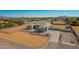 Aerial view of a charming home with desert landscape, fencing, and a long driveway in a rural setting at 21717 W South Mountain Ave, Buckeye, AZ 85326