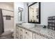 Stylish bathroom featuring a sleek vanity, granite countertop, and a decorative mirror at 21717 W South Mountain Ave, Buckeye, AZ 85326