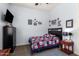 Comfortable bedroom with patriotic themed decor, dark wood furniture, ceiling fan, and ample natural light at 21717 W South Mountain Ave, Buckeye, AZ 85326