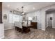 Dining room has rustic wood table, upholstered chairs, floral wallpaper, and a designer light fixture at 21717 W South Mountain Ave, Buckeye, AZ 85326