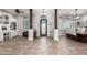 Inviting entryway features wood look tile flooring, decorative columns, and a stylish wrought iron door at 21717 W South Mountain Ave, Buckeye, AZ 85326