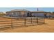 Exterior showcasing desert landscaping, fencing, and an American flag, set against a clear blue sky at 21717 W South Mountain Ave, Buckeye, AZ 85326