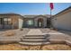 Close-up of the front entrance, showcasing the brick stairs and pathway leading to a welcoming arched doorway at 21717 W South Mountain Ave, Buckeye, AZ 85326