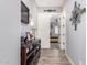 Hallway featuring wood-style flooring and neutral wall colors, leading into another room at 21717 W South Mountain Ave, Buckeye, AZ 85326