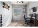 Bright home office space with modern desk setup, wood floors, and natural light from the window at 21717 W South Mountain Ave, Buckeye, AZ 85326