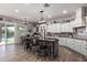 Kitchen showcases a large island with bar seating, custom cabinetry, and an open view of the outdoor pool area at 21717 W South Mountain Ave, Buckeye, AZ 85326