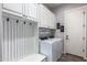 Functional laundry room with built-in cabinets, a utility sink, and modern washer and dryer at 21717 W South Mountain Ave, Buckeye, AZ 85326