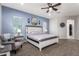 Spacious main bedroom features a ceiling fan, and neutral decor, creating a calming retreat at 21717 W South Mountain Ave, Buckeye, AZ 85326