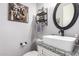 Charming powder room with decorative mirror, granite countertop, and stylish fixtures and decor at 21717 W South Mountain Ave, Buckeye, AZ 85326