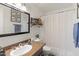 This bathroom features granite countertops, a framed mirror, and a shower with a curtain at 222 W Brown Rd # 57, Mesa, AZ 85201