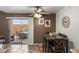 Inviting dining area with access to the patio, complemented by a ceiling fan and stylish decor at 222 W Brown Rd # 57, Mesa, AZ 85201