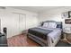 This bedroom features beautiful laminate flooring and a charming studded headboard at 222 W Brown Rd # 57, Mesa, AZ 85201