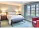 Bright bedroom featuring a large window, carpet, and a tufted bench at 2233 N 9Th Ave, Phoenix, AZ 85007