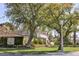 Attractive home featuring a well-manicured lawn, mature trees, and an ivy-covered outbuilding at 2233 N 9Th Ave, Phoenix, AZ 85007