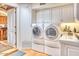 Bright laundry room with a stacked washer and dryer and ample cabinet space at 2233 N 9Th Ave, Phoenix, AZ 85007