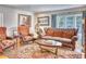 Elegant living room with a leather sofa, chairs, and a decorative rug and a taxidermied mountain lion on display at 2233 N 9Th Ave, Phoenix, AZ 85007