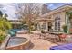 Expansive patio with dining and lounge seating, a water feature, lush landscaping, and a pool at 2233 N 9Th Ave, Phoenix, AZ 85007