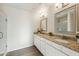 Bathroom features double sinks, granite counters, white cabinets, mirrors and a glass enclosed shower at 24942 S 190Th Dr, Buckeye, AZ 85326