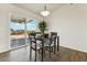 Cozy dining area with wood-look tile flooring, a modern light fixture, and sliding door access to the patio at 24942 S 190Th Dr, Buckeye, AZ 85326