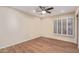 A serene bedroom with wood-look floors, ceiling fan, and plantation shutters at 2625 W Oakland St, Chandler, AZ 85224