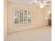 Neutral bedroom featuring large window with wooden shutters and ensuite bathroom access at 2625 W Oakland St, Chandler, AZ 85224