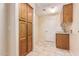 Laundry room featuring tile flooring, wood cabinets, sink, and built in storage at 2625 W Oakland St, Chandler, AZ 85224