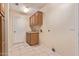 Bright laundry room with tile floors, wood cabinets and sink at 2625 W Oakland St, Chandler, AZ 85224