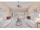 Bright living room with a ceiling fan, neutral decor, and sliding doors that lead to the pool at 2625 W Oakland St, Chandler, AZ 85224