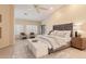 Vaulted main bedroom with plush carpet, ceiling fan and ensuite bath at 2625 W Oakland St, Chandler, AZ 85224