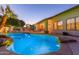 Backyard swimming pool surrounded by custom rock features and lighting at 2625 W Oakland St, Chandler, AZ 85224