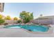 An inviting pool with rock features is surrounded by mature palm trees at 2625 W Oakland St, Chandler, AZ 85224