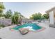 Private backyard swimming pool with rock waterfall feature and mature landscaping at 2625 W Oakland St, Chandler, AZ 85224