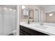 Bathroom featuring a dark cabinet, white countertop, large mirror, and shower with curtain at 2821 S Skyline Dr # 149, Mesa, AZ 85212