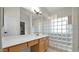 Modern bathroom features a vanity with ample counterspace and unique glass block partition at 3119 E Rosemonte Dr, Phoenix, AZ 85050