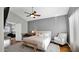 Spacious bedroom boasting a ceiling fan, study desk, white armchair, and neutral decor at 3119 E Rosemonte Dr, Phoenix, AZ 85050