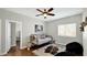 Cozy bedroom featuring a ceiling fan, area rug, window, and stylish furnishings at 3119 E Rosemonte Dr, Phoenix, AZ 85050