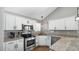 Bright kitchen with granite countertops, stainless steel appliances, and white cabinetry at 3119 E Rosemonte Dr, Phoenix, AZ 85050