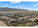 Overhead shot of a residential area showcasing houses with diverse rooftops, surrounded by trees and desert landscape at 3132 E Harwell Rd, Phoenix, AZ 85042