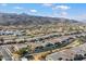 An aerial view of homes with well-kept yards in a community near mountains, displaying an attractive desert suburb at 3132 E Harwell Rd, Phoenix, AZ 85042