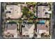 A high-angle view showing multiple backyard designs with pools, putting greens, and manicured landscaping, offering luxurious outdoor living at 3132 E Harwell Rd, Phoenix, AZ 85042