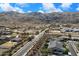 Aerial view of the neighborhood, featuring residential homes with desert landscaping and mountain views at 3132 E Harwell Rd, Phoenix, AZ 85042