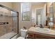 Bathroom features a tiled shower, vanity, and ample natural light at 3132 E Harwell Rd, Phoenix, AZ 85042