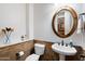 Cozy powder room with pedestal sink, decorated walls, and classic finishes at 3132 E Harwell Rd, Phoenix, AZ 85042