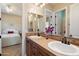 Well-lit bathroom with dual sinks, and decorative fixtures at 3132 E Harwell Rd, Phoenix, AZ 85042