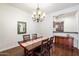 Cozy dining room with wooden furniture and a chandelier at 3132 E Harwell Rd, Phoenix, AZ 85042