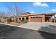 Front exterior of a tan home with a two-car garage at 3132 E Harwell Rd, Phoenix, AZ 85042