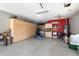 Spacious garage with ample cabinet storage, sink, and epoxy flooring at 3132 E Harwell Rd, Phoenix, AZ 85042